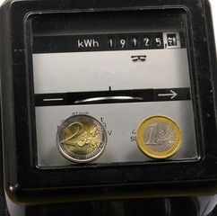 electric counter kwh to measure the electricity consumed and euro coins