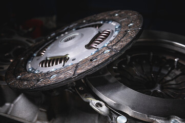 Automotive clutch mechanism, disc, basket and bearing for auto on a black background. Automotive parts. Close-up