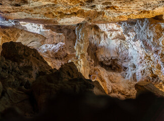  Interior of a cave, with a large pillar of stalactites and stalagmites