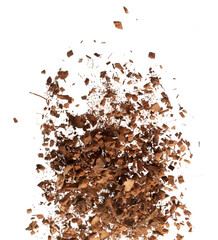 Coconut peel husk flying explosion, coconut chopped medium M size abstract fall down garden. Coconut shell peel fertilizer splash throwing in Air. White background Isolated high speed shutter, freeze