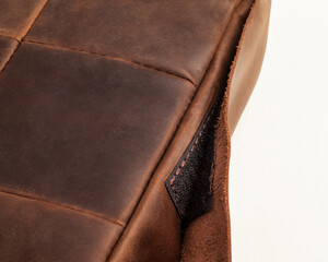 Closeup of brown leather seat cushion with hook-and-loop fastener