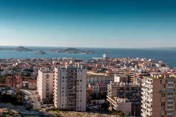 Naklejka premium Marseille, France - FEB 28, 2022: Beautiful horizon view with golden sunlight from the coast of Marseille