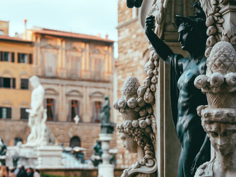 Close-up of the pedestal statue of Perseus and the Medusa and Fountain of Neptune in Florence, Italy, situated on the Piazza della Signoria 