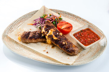 Fried sausage with cheese, fresh vegetable salad and salsa sauce.