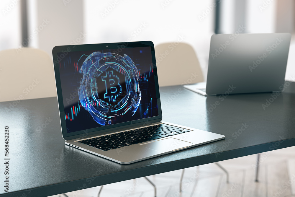 Poster close up of laptop computer on desktop with glowing bitcoin hologram on blurry background. money, di