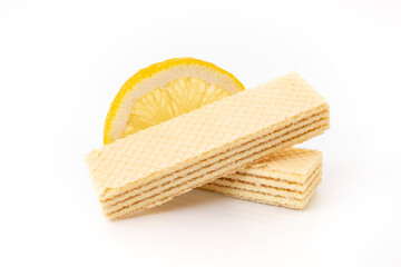 two wafers and a slice of lemon on white