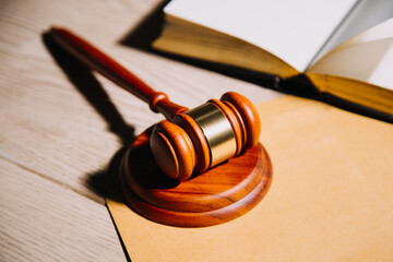 Justice and law concept.Male judge in a courtroom with the gavel, working with, computer and docking keyboard, eyeglasses, on table in morning light