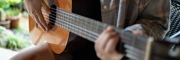 Happy young Woman hands playing acoustic guitar musician  alone compose instrumental song lesson on playing the guitar