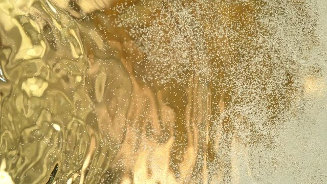 Super Slow Motion Shot of Waving and Fizzing Fresh Champagne Background at 1000fps.