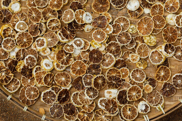 Kaffir lime fruits are sliced into thin slices. dried on the basket for use in the production of Thai herbal medicines