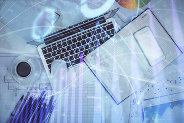 Multi exposure of forex chart drawing over table background with computer. Concept of financial research and analysis. Top view.