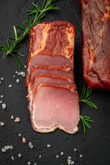 Smoked jerky on a dark background. Natural product from organic farm