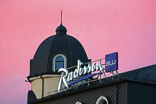 KYIV, UKRAINE - AUGUST 4, 2018: Radisson Blu Hotel Kyiv Podil is located in the historic district of the city - Podil. View of the top of the buildinf on the sunset