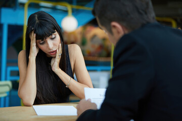 woman applicant feeling nervous and headache when hr recruitment officer holding resume and asking something at job interview, considering employee candidature for open work position