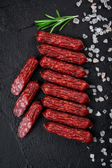 Smoked sausages of the highest quality.. On a black background.