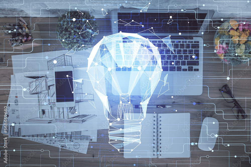 Poster bulb drawing over computer on the desktop background. top view. double exposure. idea concept.