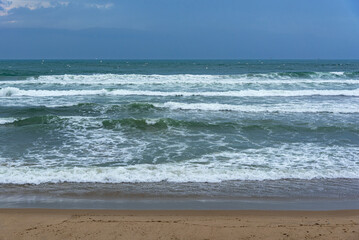 Storm sea. Waves on the sea dispersed by the wind on a cloudy day.