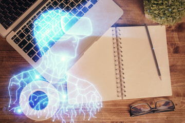 AR hologram drawings over computer on the desktop background. Top view. Multi exposure. Concept of augmented reality.