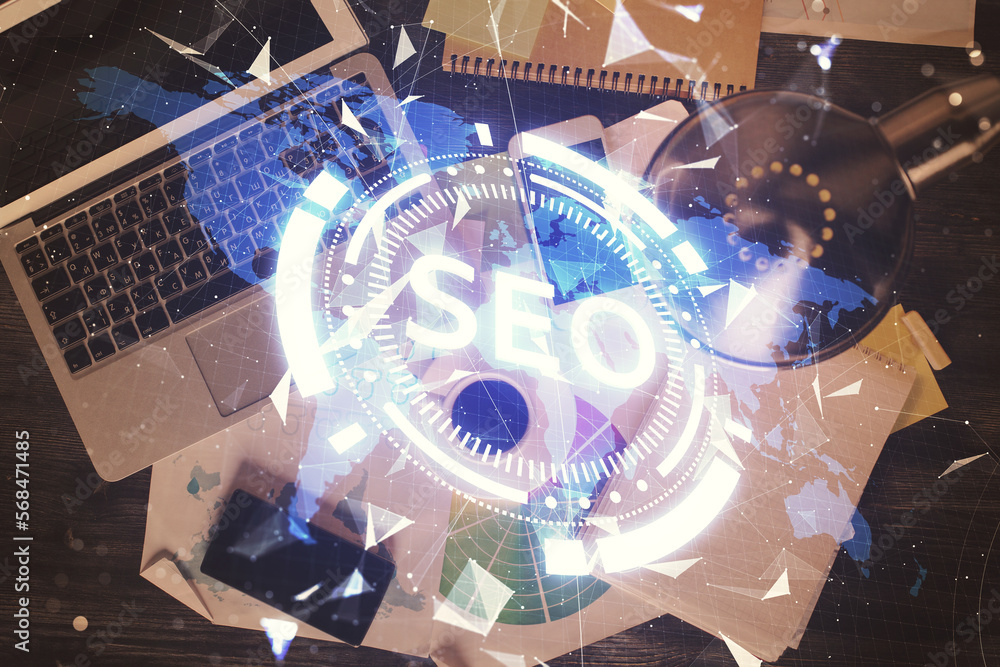 Poster Double exposure of SEO drawing over study table background with computer. Concept of search. Top view.
