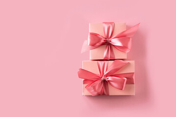 Two pink gift box with bow on pink background