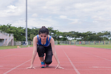 Fototapeta premium beautifull sport girl exercise at the track court and wearing blue sport bra