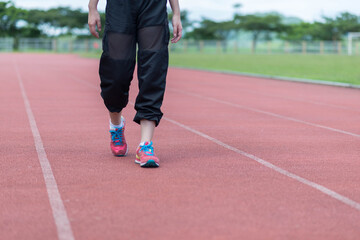 Fototapeta premium beautifull sport girl exercise at the track court and wearing blue sport bra