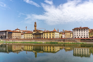 Sunny view over the River Arno in Florence in Tuscany Italy with its most famous medieval building the Palazzo Vecchio or the town hall and Santa Maria del Fiore or Il Duomo