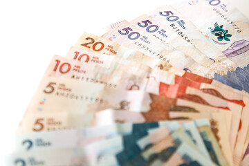 Obraz premium Macro closeup of Colombian pesos of different value in the shape of a fan on a white background
