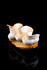 Mini eclair with pistachio and seared meringue.