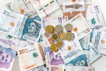 Colombian pesos coins on bills of different denominations