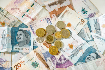 Macro closeup of Colombian peso coins on banknotes of different denominations