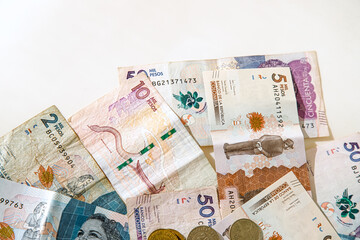 Macro closeup of Colombian peso bills on white background
