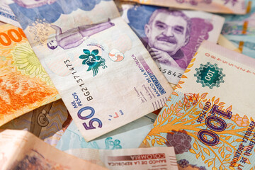 Macro closeup of Colombian pesos and Argentine pesos