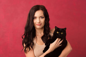 Beautiful woman holding a black cat