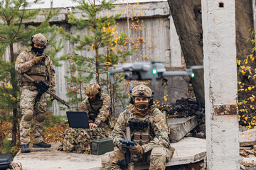 Modern army soldiers using aerial drone for artillery guidance and scouting view enemy positions in military operation