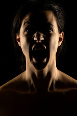 Fototapeta premium Silhouette of young unhappy woman on black background