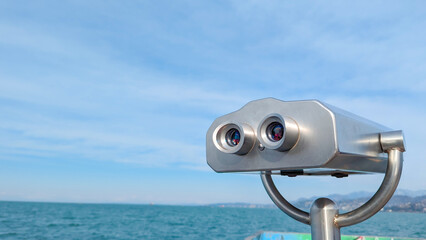 Watching black sea through binoculars telescope. travel and tourism. Coin-operated binocular at Batumi Georgia. 