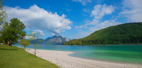 bathing beach lake Walchensee, mountain view  bavarian landscape. blue sky with clouds