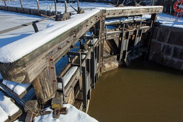 Gates of closed canal lock in winter covered with snow, Struka, Finland.