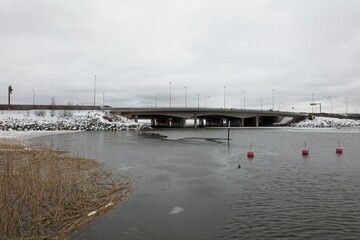 Fototapeta na wymiar Bridge between Helsinki and Espoo in cloudy weather in winter, Karhusaari, Espoo, Finland.