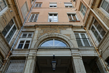 LYON, FRANCE, February 4, 2023 : Famous traboule in Croix-Rousse district. Traboules are a type of passageway under houses originally used by silk manufacturers.