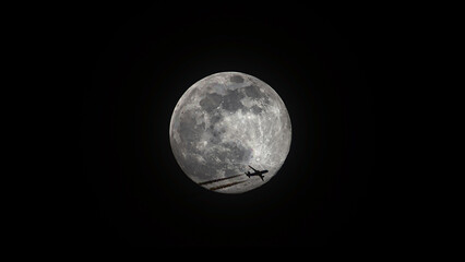 Airliner passing by a full moon