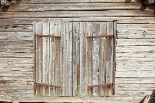 Wooden doors with rusty hinges on a old building in spring, Kemiönsaari, Finland.