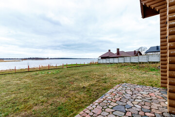 Wooden house with beautiful lake. Homeliness and home comfort at the countryside far from civilization