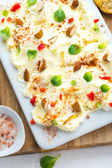 Butter board topped with toasted garlic, almond, microgreens, pink salt, chili peppers and paprika served with garlic croutons. Trend Tic Tok influencer food