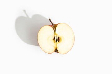 Half of a cut apple on a white background. Top view, flat lay