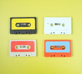 a large collection of retro cassette tapes places in a grid on green background