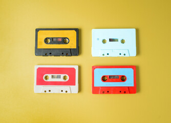 a large collection of retro cassette tapes places in a grid on green background