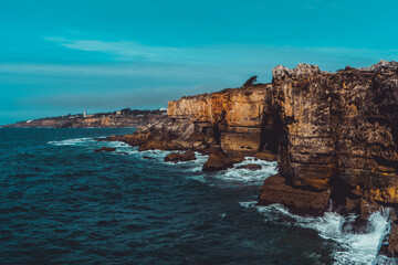 Brave the edge of a cliff for breathtaking views of the turquoise sea in Portugal