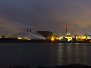 Fototapeta na wymiar January 2023, Dunkerque - Winter walk on the Break dam - View on an industrial site 